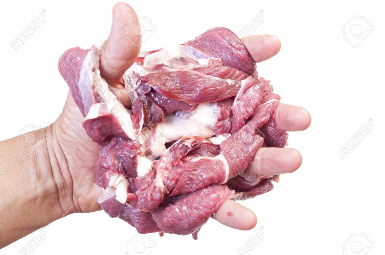closeup of human hand holding one pound of raw sliced beef on