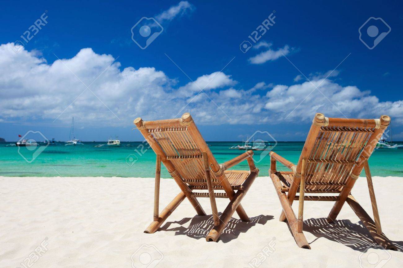 two beach chairs on perfect tropical white sand beach in boracay