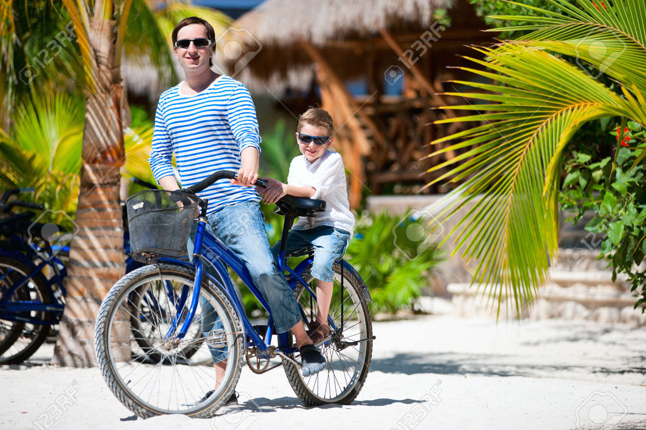 Father And Son Riding A Bike Together Stock Photo, Picture And ...
