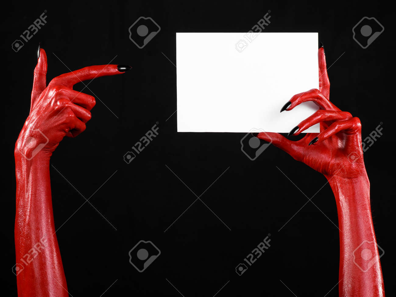 Halloween Theme Red Devil Hand With Black Nails Holding A Blank Stock Photo Picture And Royalty Free Image Image 56173176