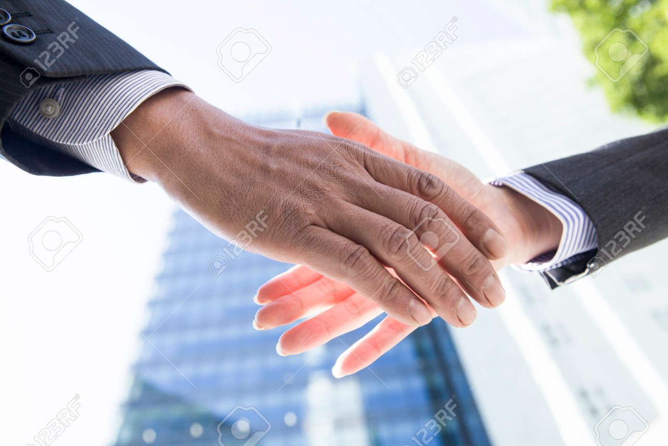 Office workers shaking hands - 52338488 Office workers shaking hands - 52338488