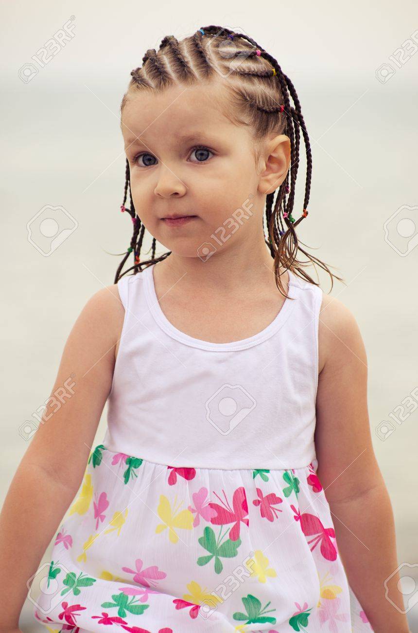 Portrait Of Little Girl With Dreadlocks On The Beach