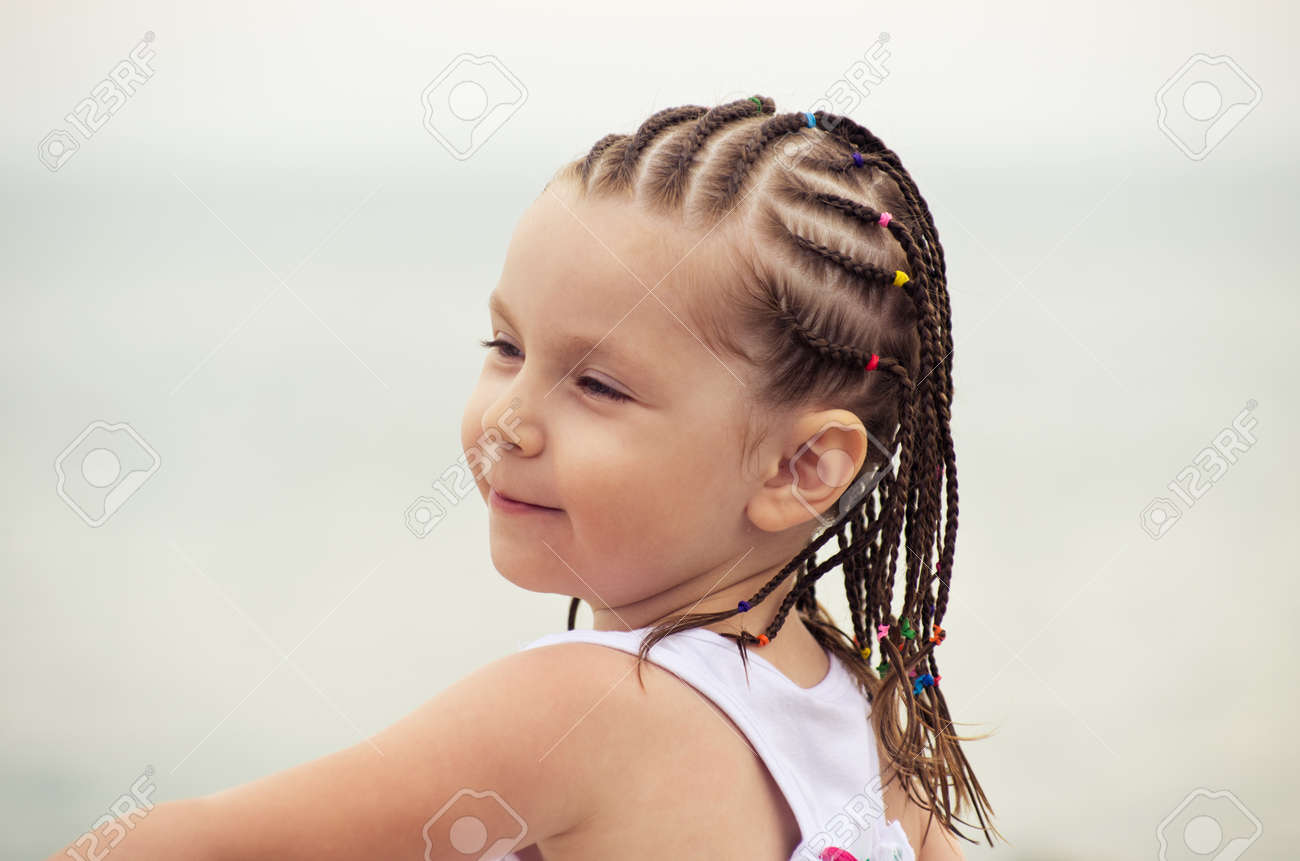Portrait Of Little Girl With Dreadlocks On The Beach