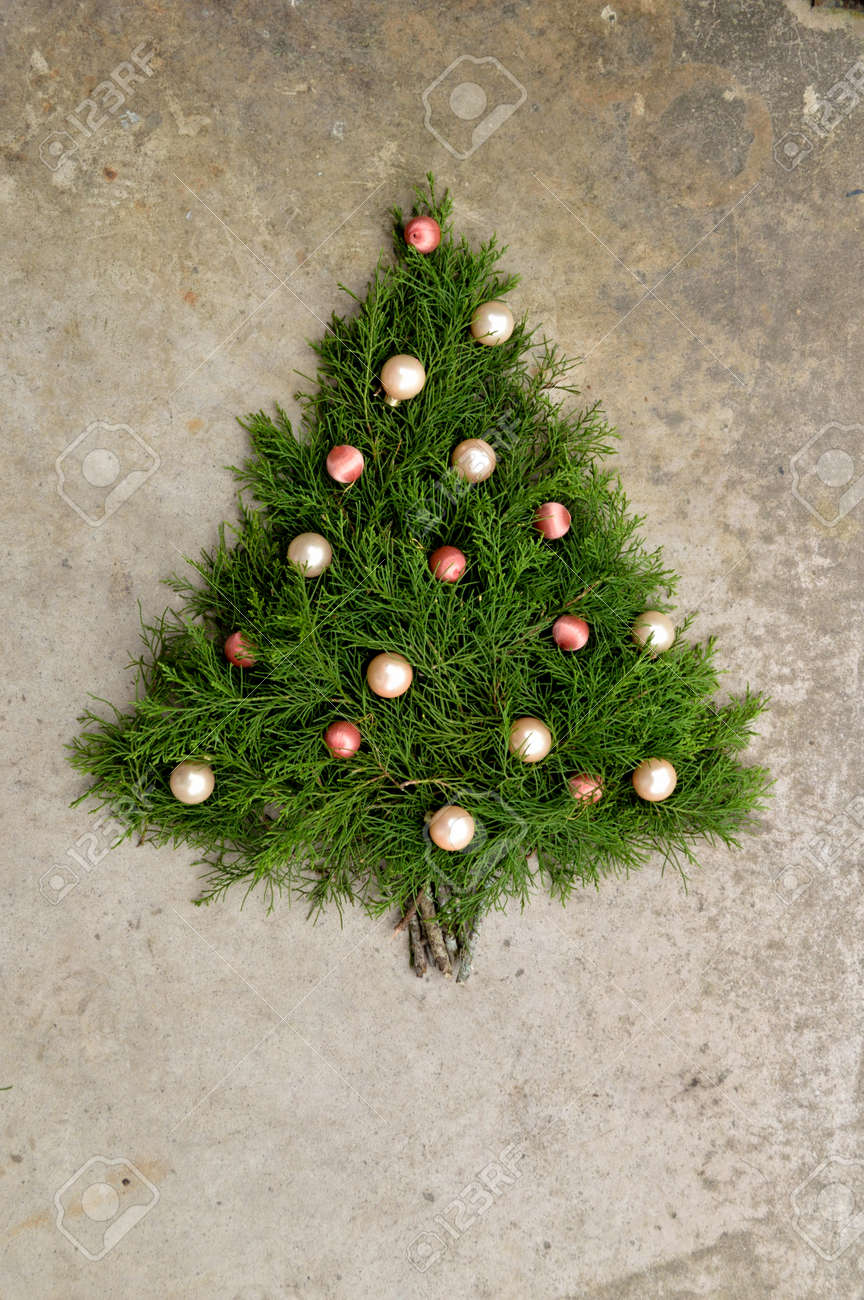Christmas Tree Made Out Of Cedar Branches With Peach And Pink Ball Ornaments On It Christmas Tree Made Out Of Cedar Branches With Peach And Pink Ball Ornaments On It