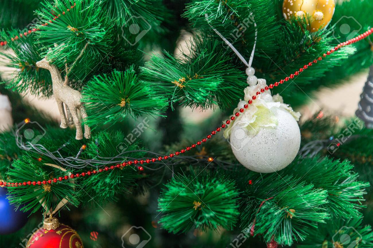 Bright White Ball Hanging On A Christmas Tree Fluffy Green With Toys And Bright White Ball Hanging On A Christmas Tree Fluffy Green With Toys And