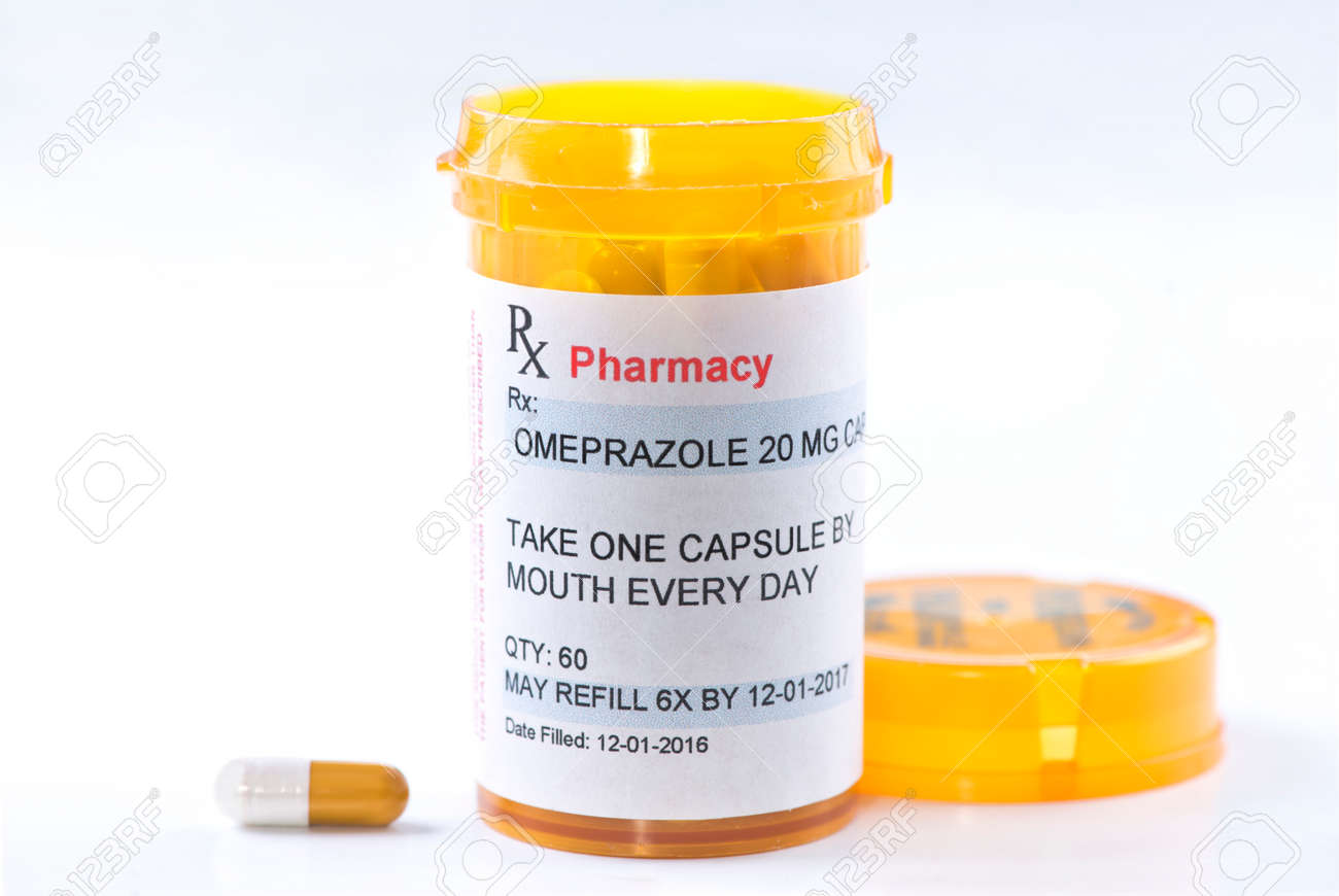 omeprazole prescription bottle with side effects info sheet stock