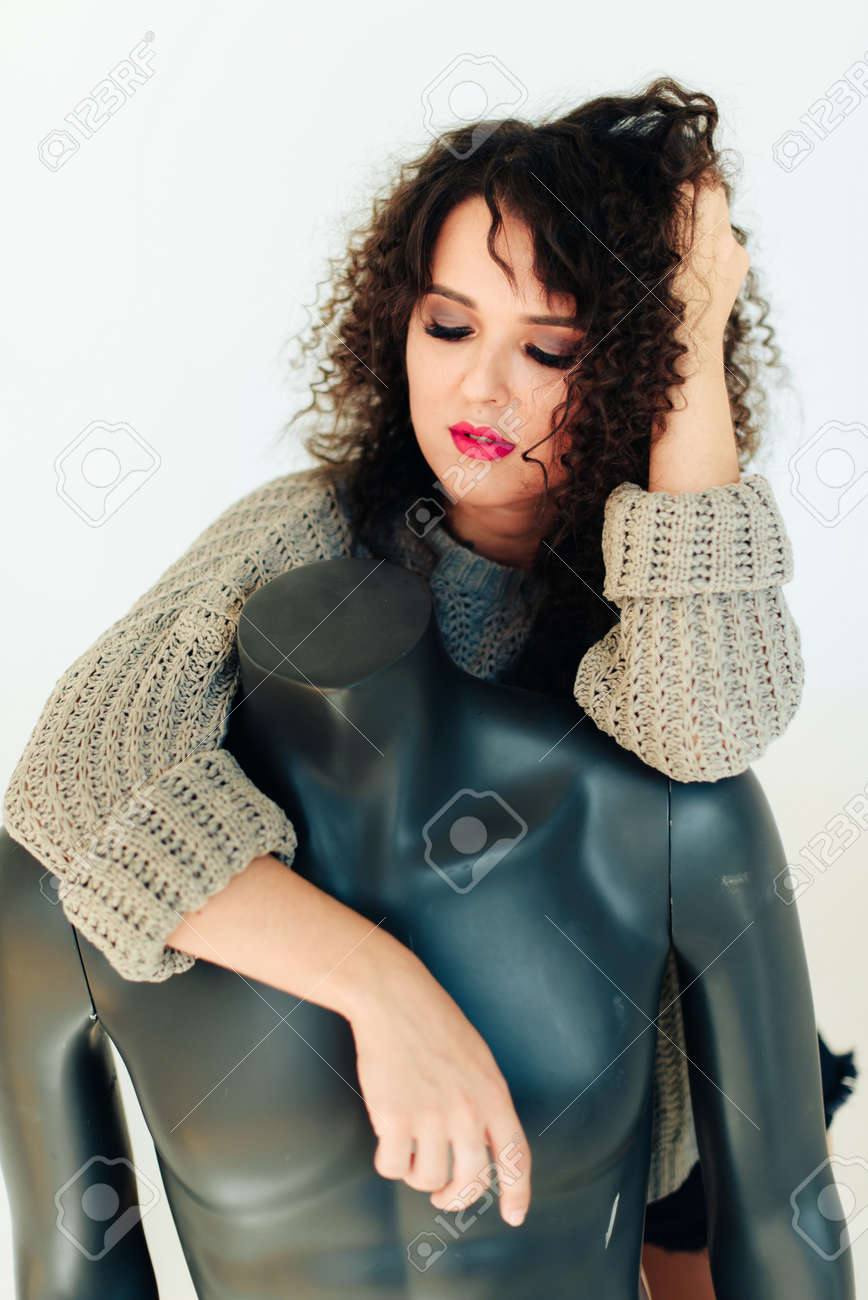 Curly Beautiful Brunette Girl With Short Hair In A Warm Sweater