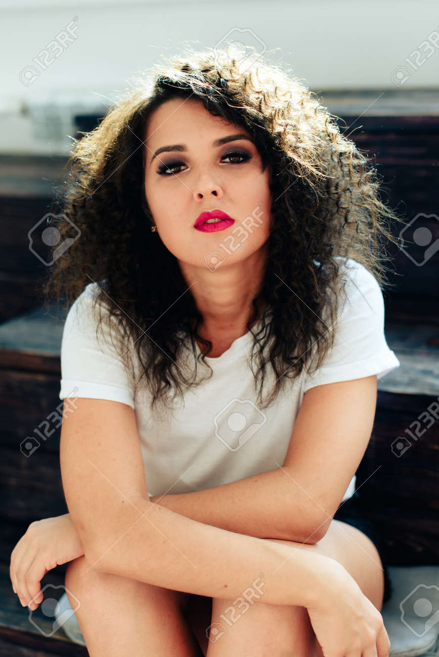Curly Beautiful Brunette Girl With Short Hair In A Warm Sweater