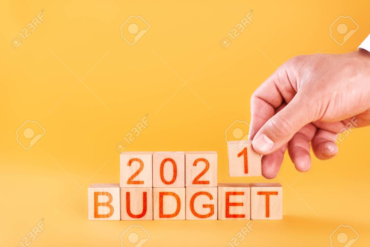 budget 2021 concept. male hand stacks wooden blocks with the inscription budget 2021 - 150534085 budget 2021 concept. male hand stacks wooden blocks with the inscription budget 2021 - 150534085