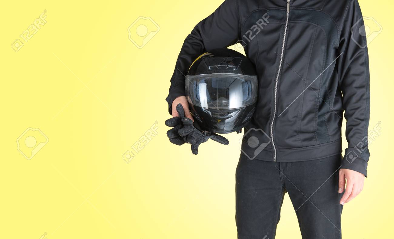 Download Biker With Holding Motorcycle Helmet On Yellow Background Text Stock Photo Picture And Royalty Free Image Image 92685780 PSD Mockup Templates