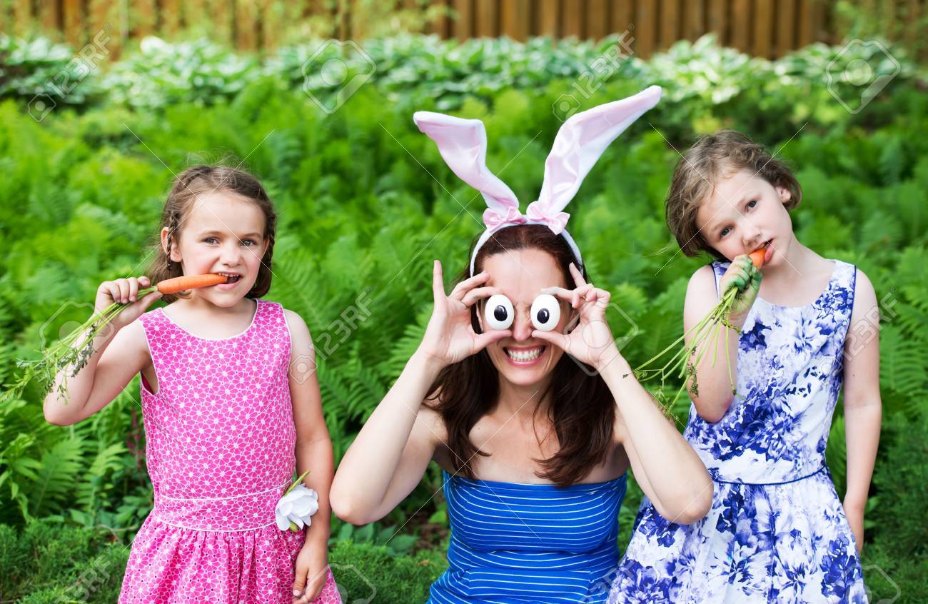 a funny family portrait on easter of a mother wearing bunny ears