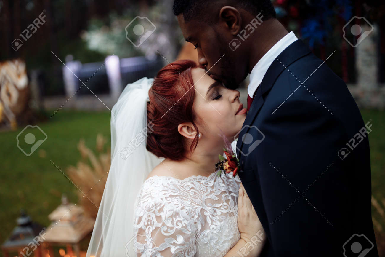 https://previews.123rf.com/images/shunevich/shunevich2103/shunevich210300248/166159116-portrait-of-lovely-couple-on-wedding-ceremony-handsome-african-american-man-with-adorable-white-woma.jpg