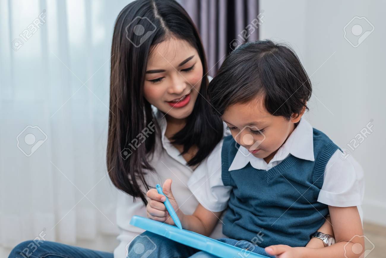 Asian Mom Teaching Cute Boy To Drawing