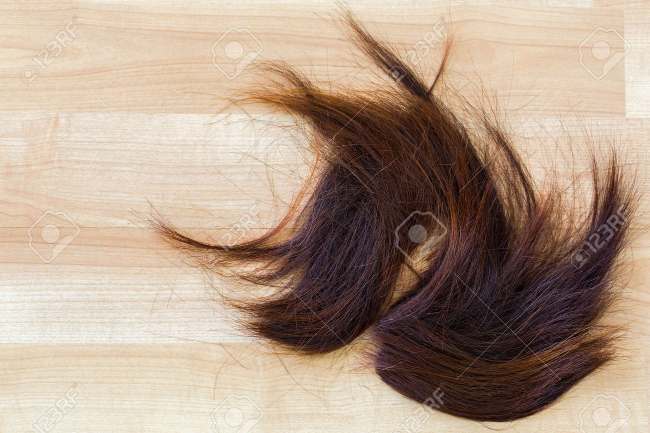 Bunch Of Trimmed Cut Off Reddish Brown Hair On Wooden Floor At