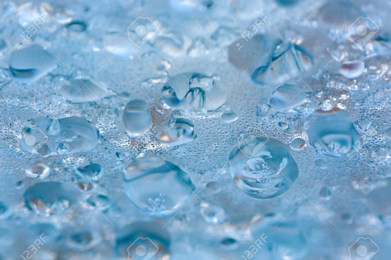 Drop Of Frozen Water Dripping From The Blue Transparency Ceiling