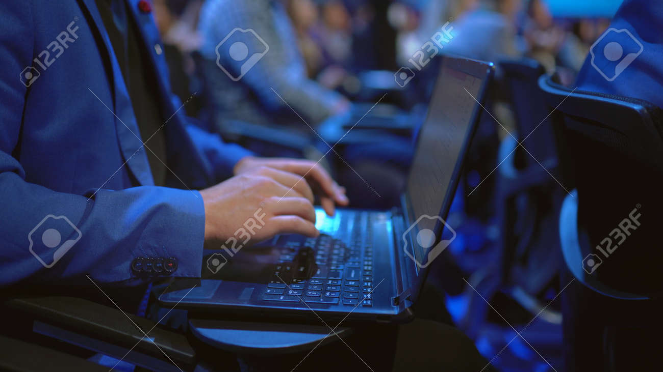 Person type keyboard crowded audience business forum. Viewer seminar listen speaker auditorium. Business man typing notebook political summit. Group people learning education speech in crowd audience - 157271887 Person type keyboard crowded audience business forum. Viewer seminar listen speaker auditorium. Business man typing notebook political summit. Group people learning education speech in crowd audience - 157271887