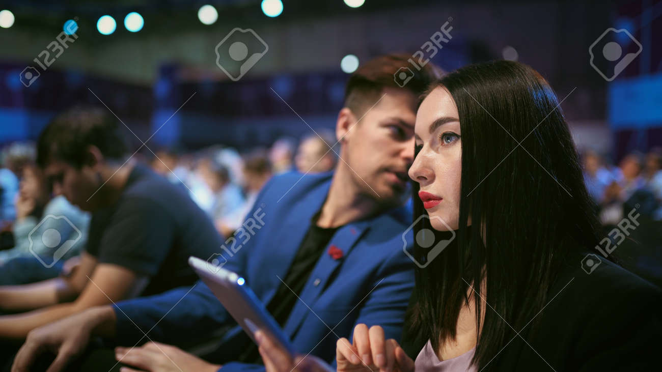 Business audience crowded forum. Persons serious discussion seminar. Woman and man listen speaker in auditorium. Viewer business men economic summit . Group people discussing speech in crowd audience. - 156060007 Business audience crowded forum. Persons serious discussion seminar. Woman and man listen speaker in auditorium. Viewer business men economic summit . Group people discussing speech in crowd audience. - 156060007