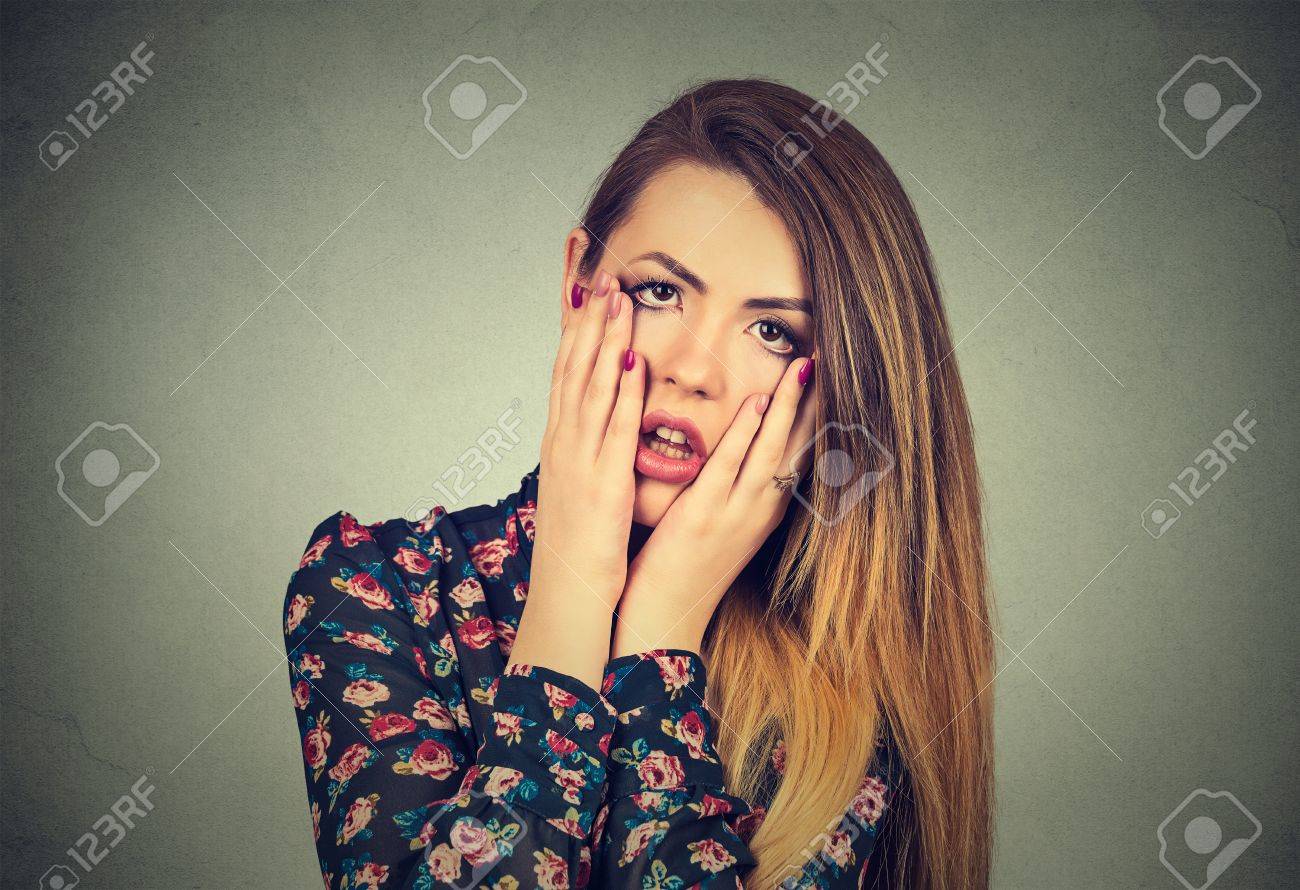 Closeup portrait of frustrated stressed woman with hands on face upset about to cry isolated on gray wall background. Negative human emotion facial expression feelings, body language reaction - 55040218 Closeup portrait of frustrated stressed woman with hands on face upset about to cry isolated on gray wall background. Negative human emotion facial expression feelings, body language reaction - 55040218