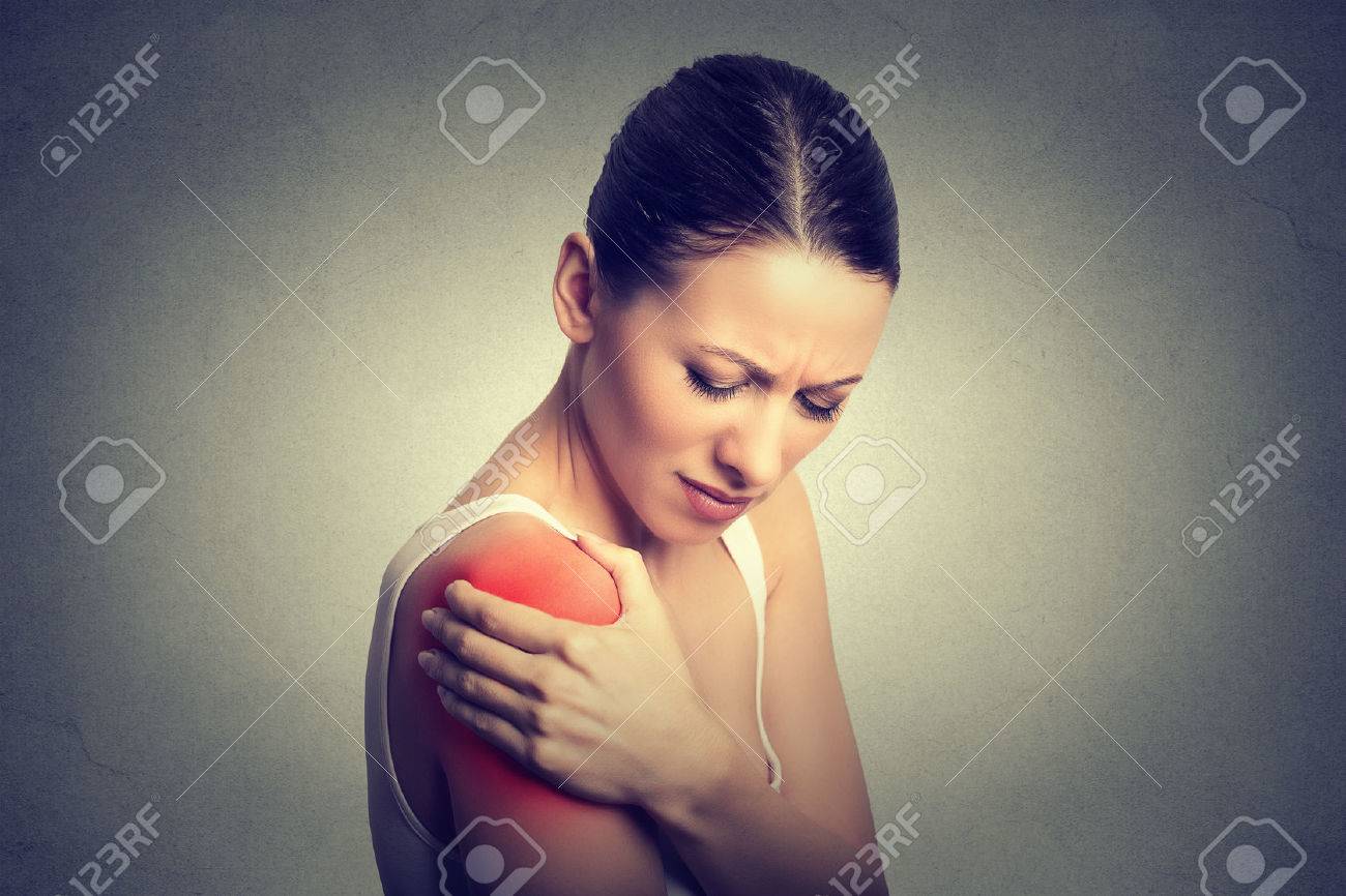 Injured joint. Young woman patient in pain having painful shoulder colored in red. Medicine and health care concept. Gray background - 55040334 Injured joint. Young woman patient in pain having painful shoulder colored in red. Medicine and health care concept. Gray background - 55040334