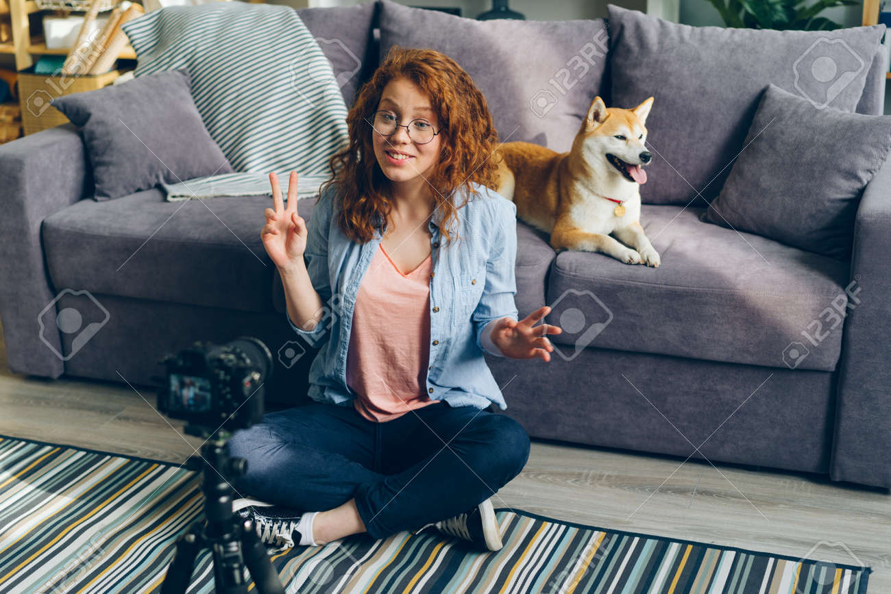 Happy Young Woman Is Recording Video About Pedigree Shiba Inu