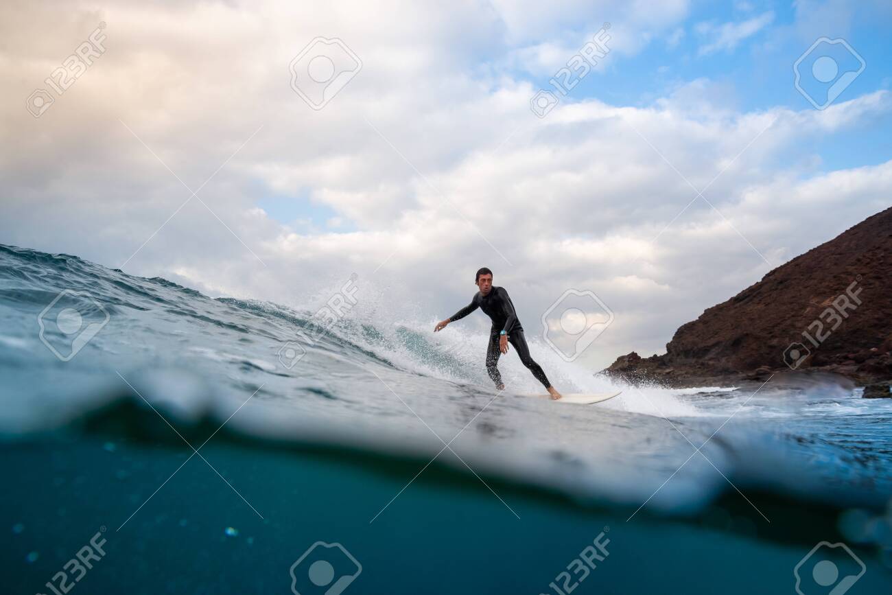 Surfer riding waves on the island of fuerteventura in the Atlantic Ocean, Canary Islands - 139618257 Surfer riding waves on the island of fuerteventura in the Atlantic Ocean, Canary Islands - 139618257