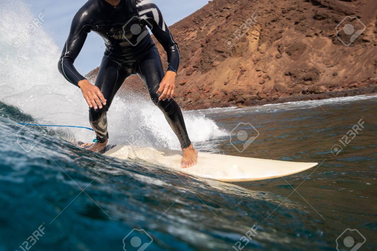 Surfer riding waves on the island of fuerteventura in the Atlantic Ocean, Canary Islands - 140634111 Surfer riding waves on the island of fuerteventura in the Atlantic Ocean, Canary Islands - 140634111