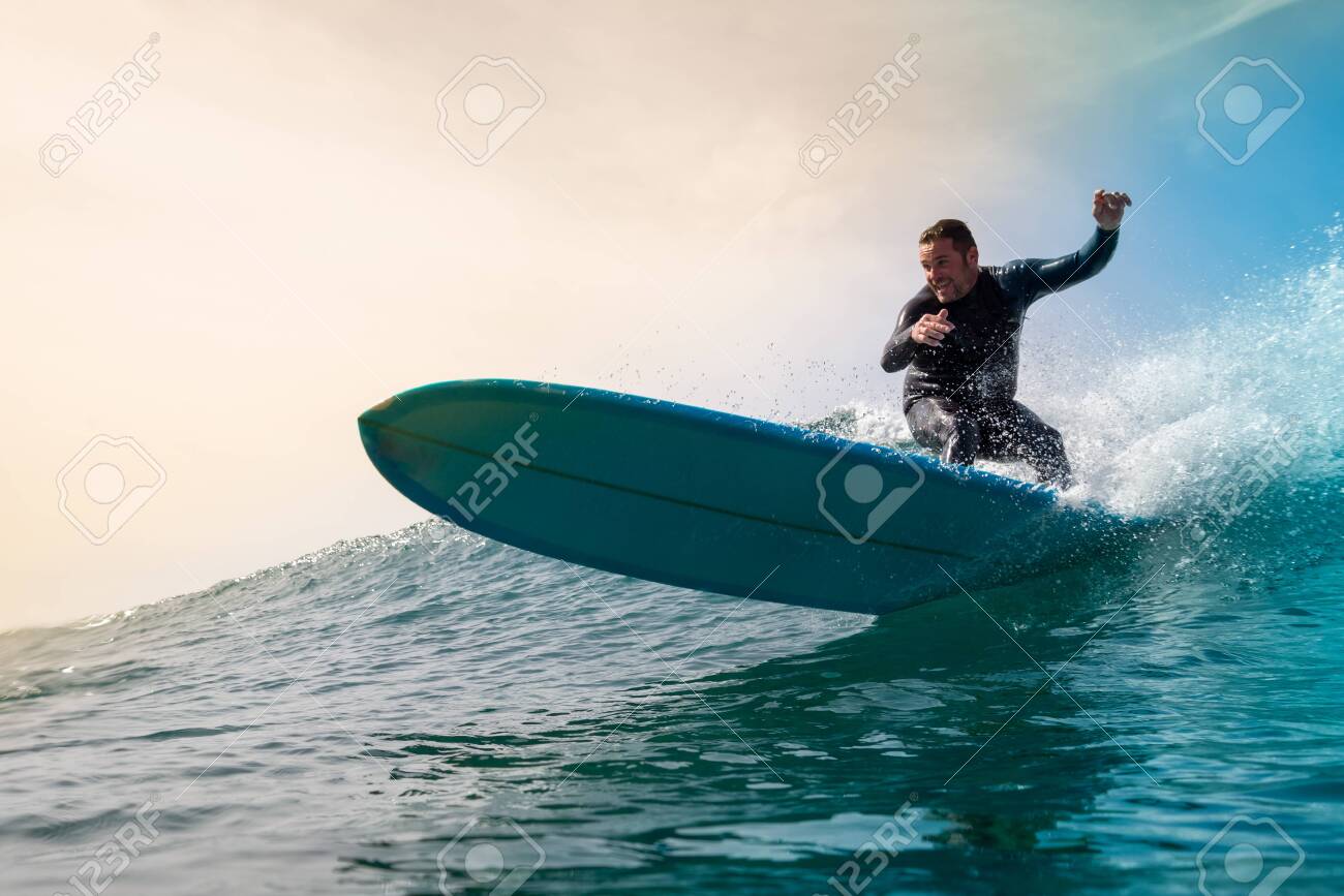 Surfer riding waves on the island of fuerteventura - 142109347 Surfer riding waves on the island of fuerteventura - 142109347