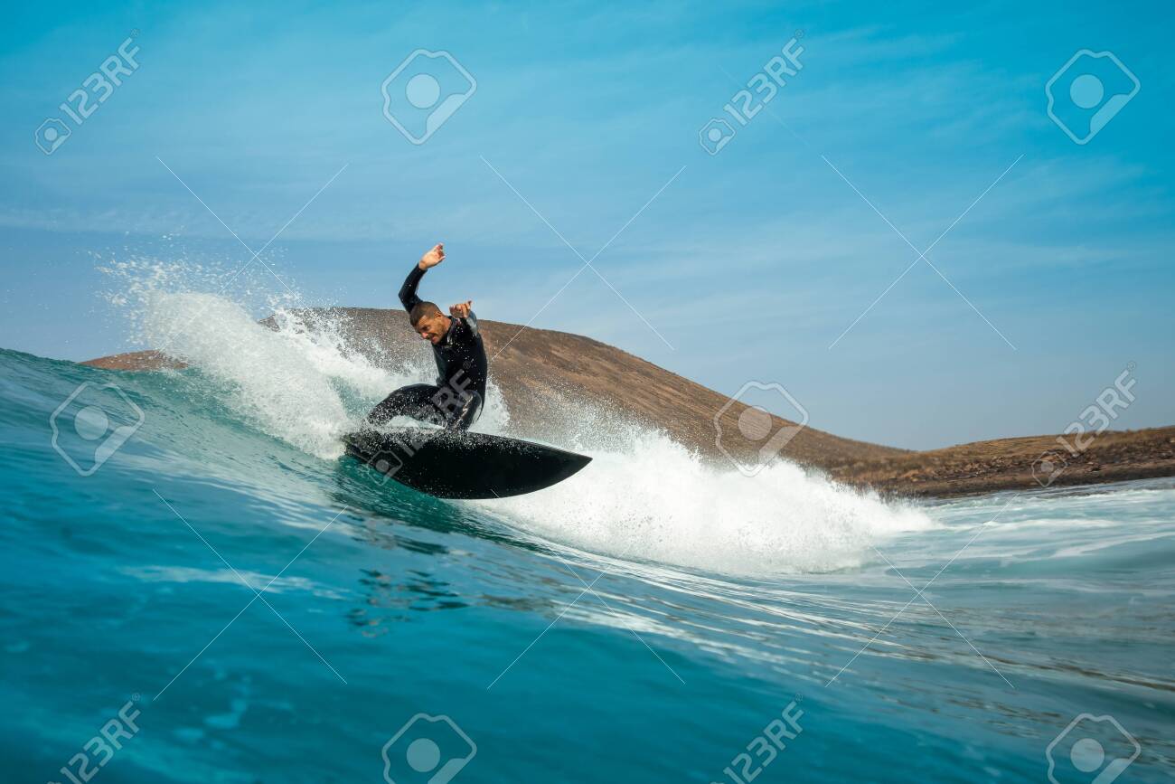 surfer riding waves on the island of fuerteventura - 143160044 surfer riding waves on the island of fuerteventura - 143160044