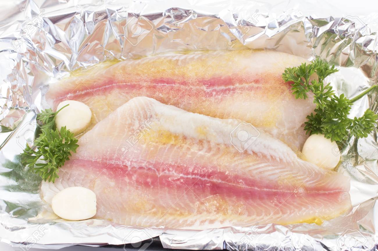 Filets De Poisson Chat à Lhuile Dolive à Lail Et Au Persil En Feuilles Prêts Pour La Cuisson