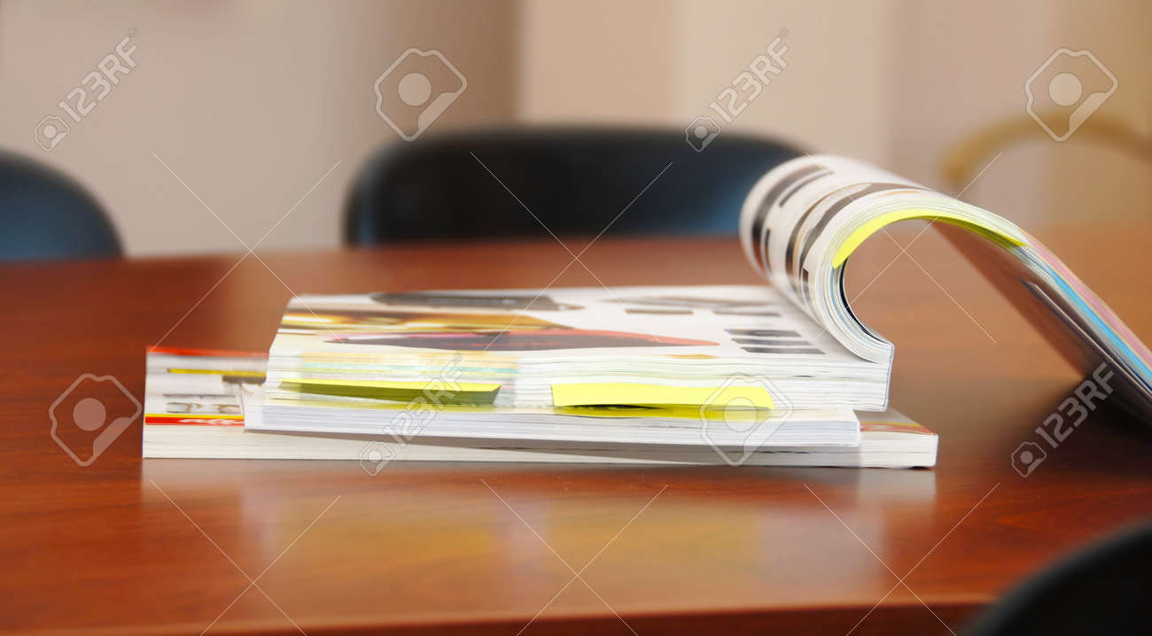 opened magazines on brown business desk indoor - 10411083 opened magazines on brown business desk indoor - 10411083