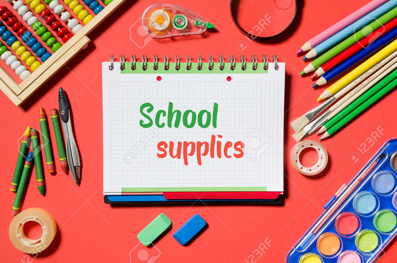 notepad with school supplies words and office stationery red