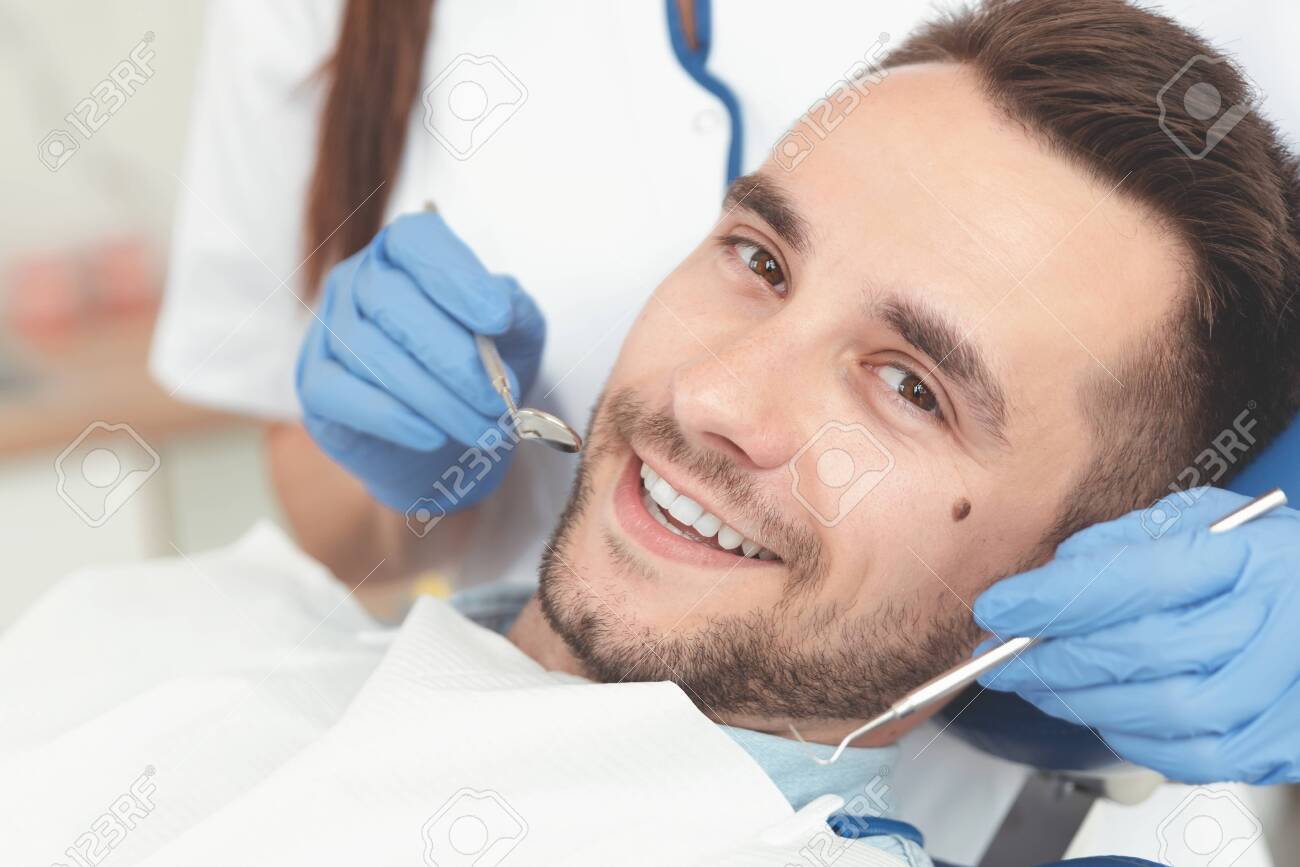 Young Man At The Dentist. Dental Care, Treatment Of Teeth, Taking Care Of Teeth Stock Photo, Picture and Royalty Free Image. Image 127501315.
