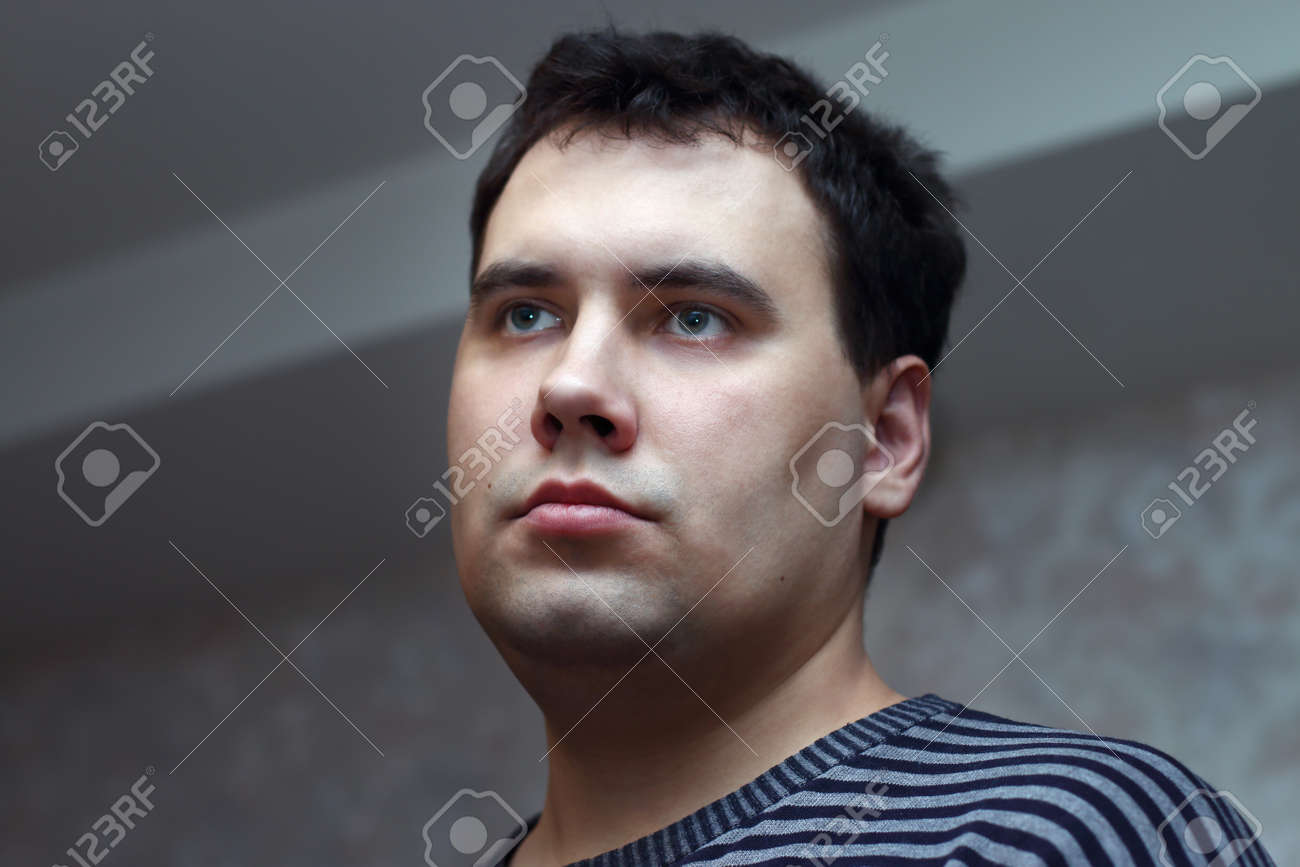 Closeup Face Of Young Handsome Man With Black Hair And Green