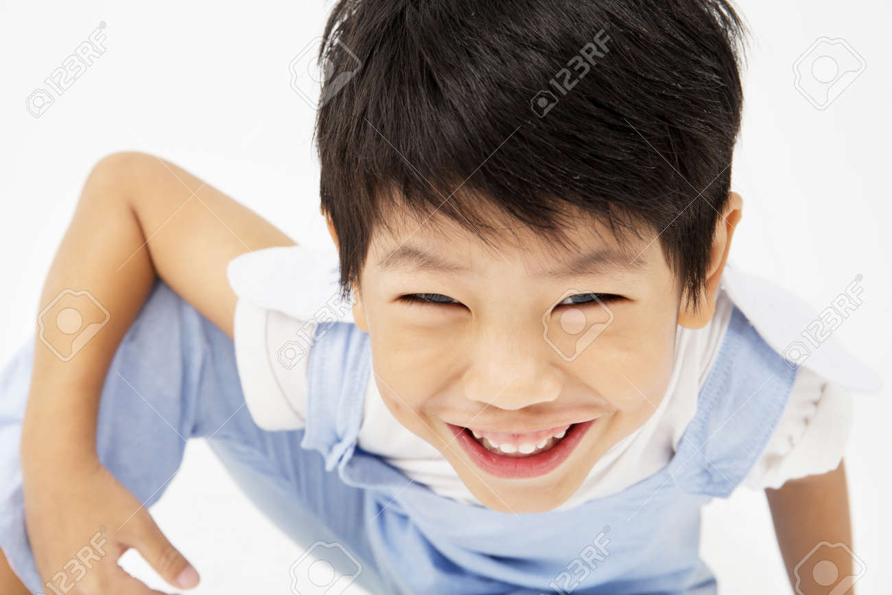 Happy asian cute boy with smile face on gray background - 66109982 Happy asian cute boy with smile face on gray background - 66109982