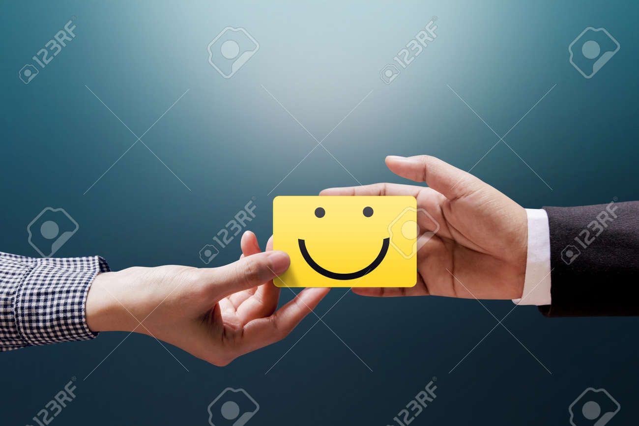 Customer Experience Concept, Happy Client Woman giving a Feedback with Happy Smiley Face Card into a Hand of Businessman - 92103675 Customer Experience Concept, Happy Client Woman giving a Feedback with Happy Smiley Face Card into a Hand of Businessman - 92103675
