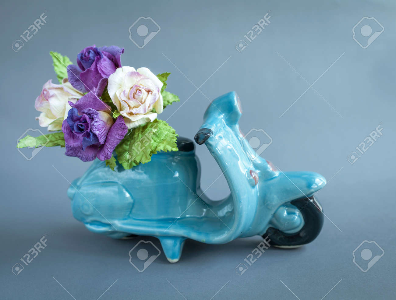 rose paper flower on ceramic blue scooter flower delivery service paper flower delivery