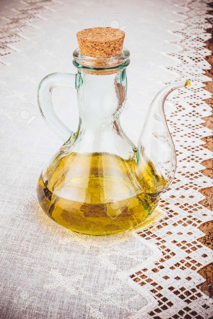 https://previews.123rf.com/images/sise/sise1706/sise170600033/79801056-extra-virgin-olive-oil-in-rustic-bottle-on-old-wooden-table-vertical-image.jpg