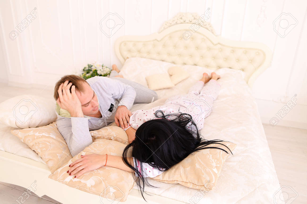 Young Happy Family Together Girl And Guy Embracing In Bed Wife