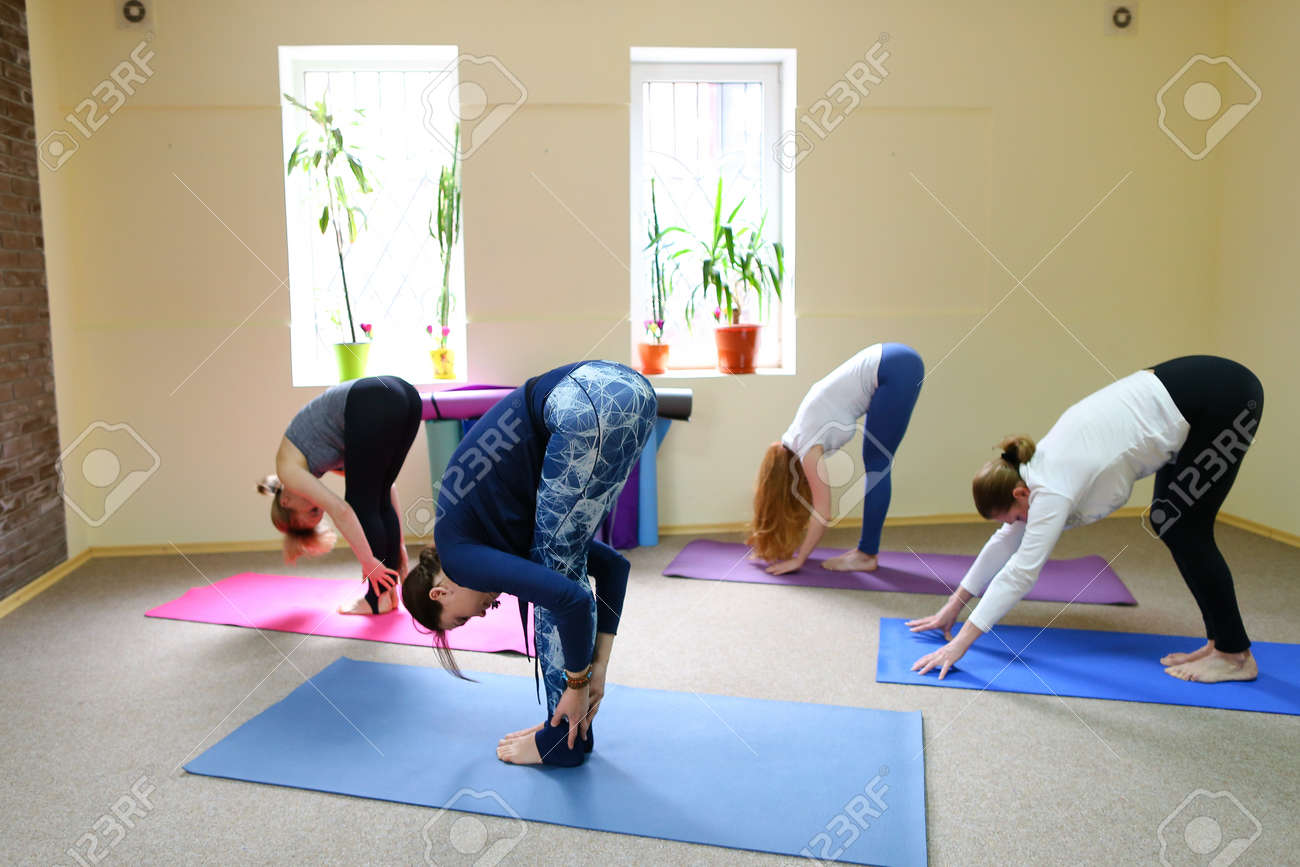 Sports woman works with muscles of arms and legs in chair pose Sports woman works with muscles of arms and legs in chair pose