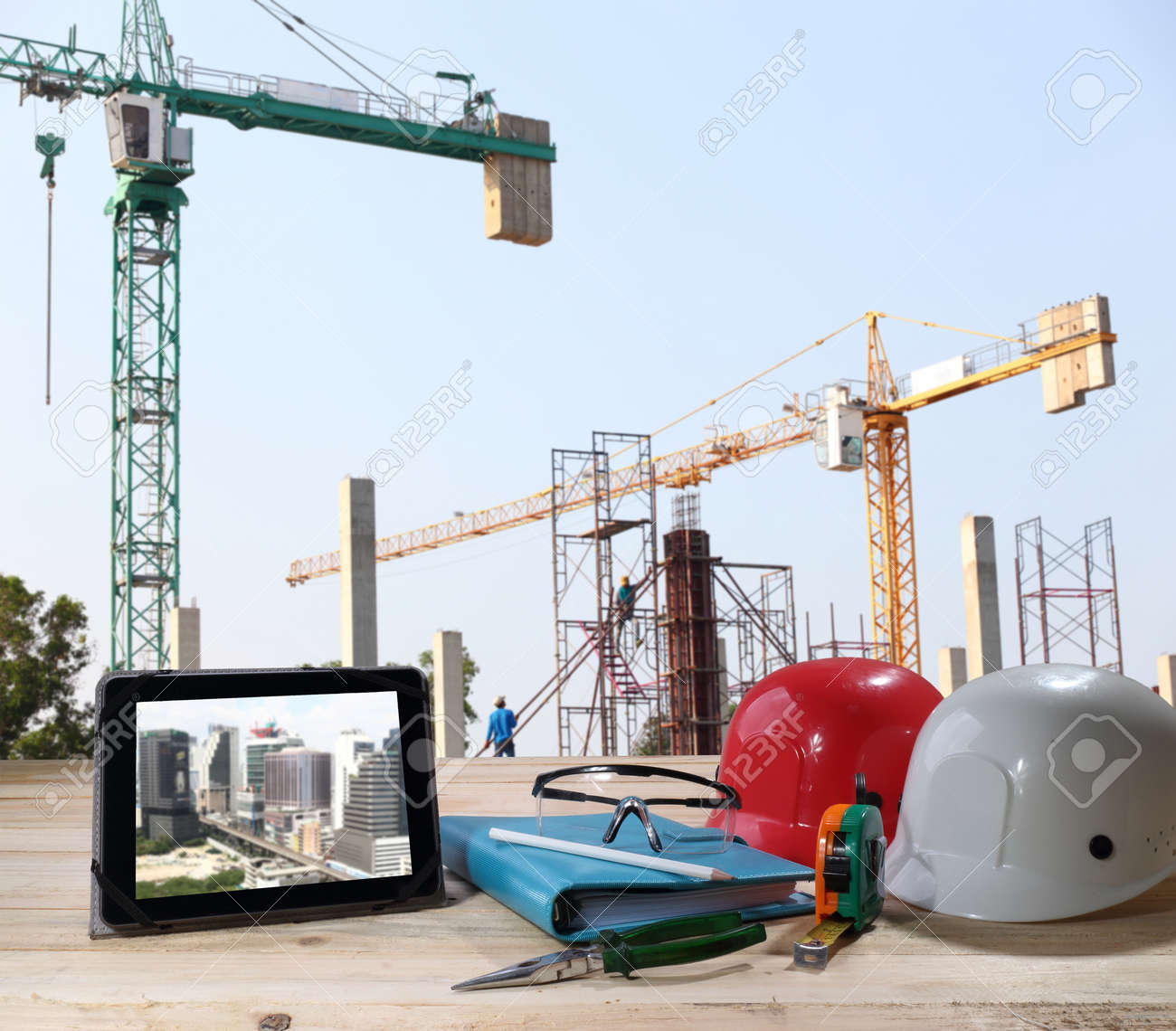 file of safety helmet and safety glasses on wood table in front of building construction background - 40644822 file of safety helmet and safety glasses on wood table in front of building construction background - 40644822