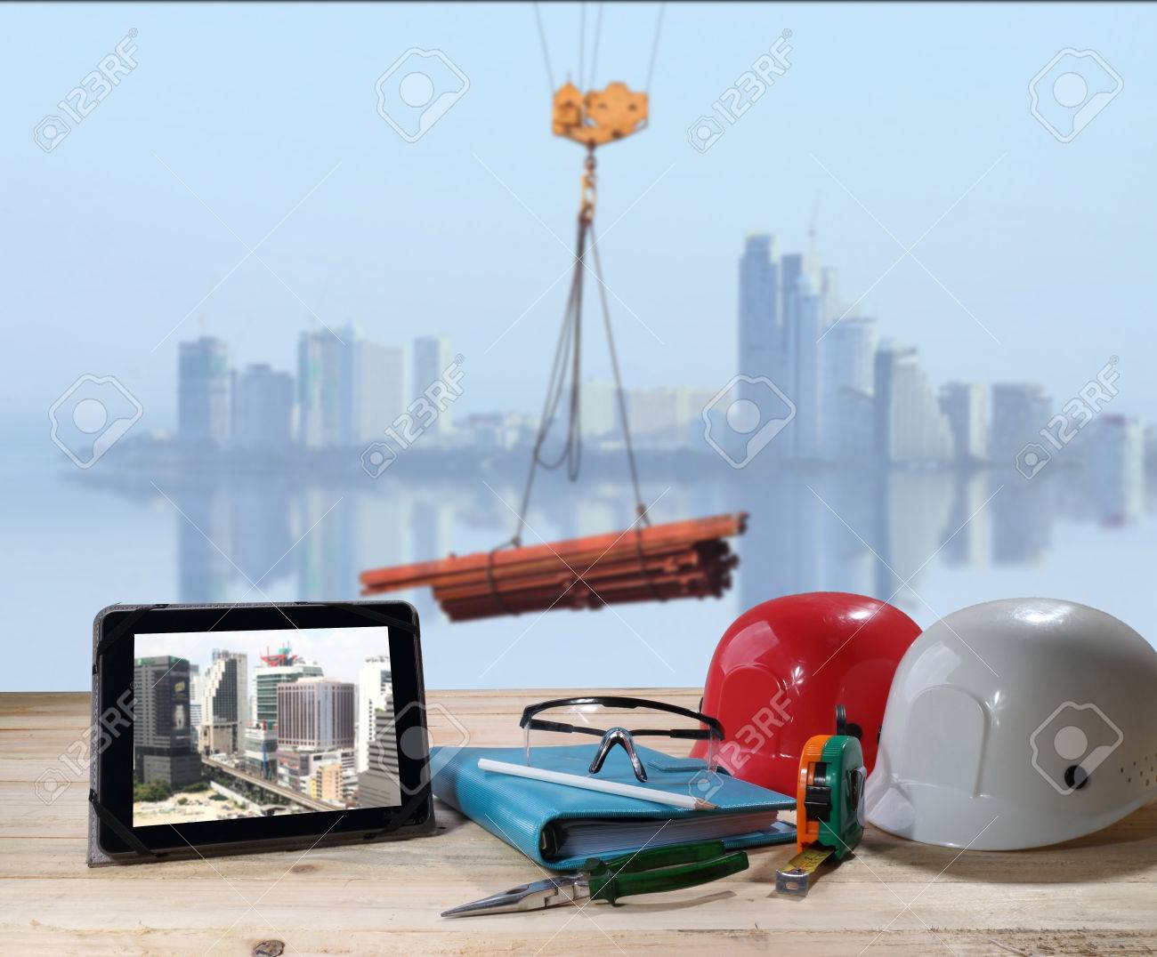 file of safety helmet and safety glasses on wood table in front