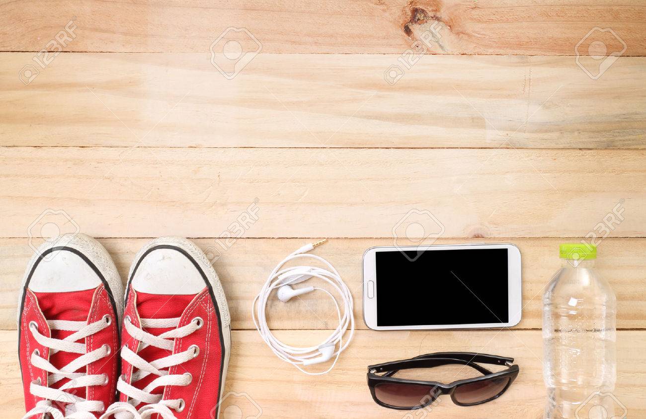 Outfit of traveler, student, teenager, young woman or guy. Overhead of essentials for modern young person. Different objects on wooden background. - 41293765 Outfit of traveler, student, teenager, young woman or guy. Overhead of essentials for modern young person. Different objects on wooden background. - 41293765