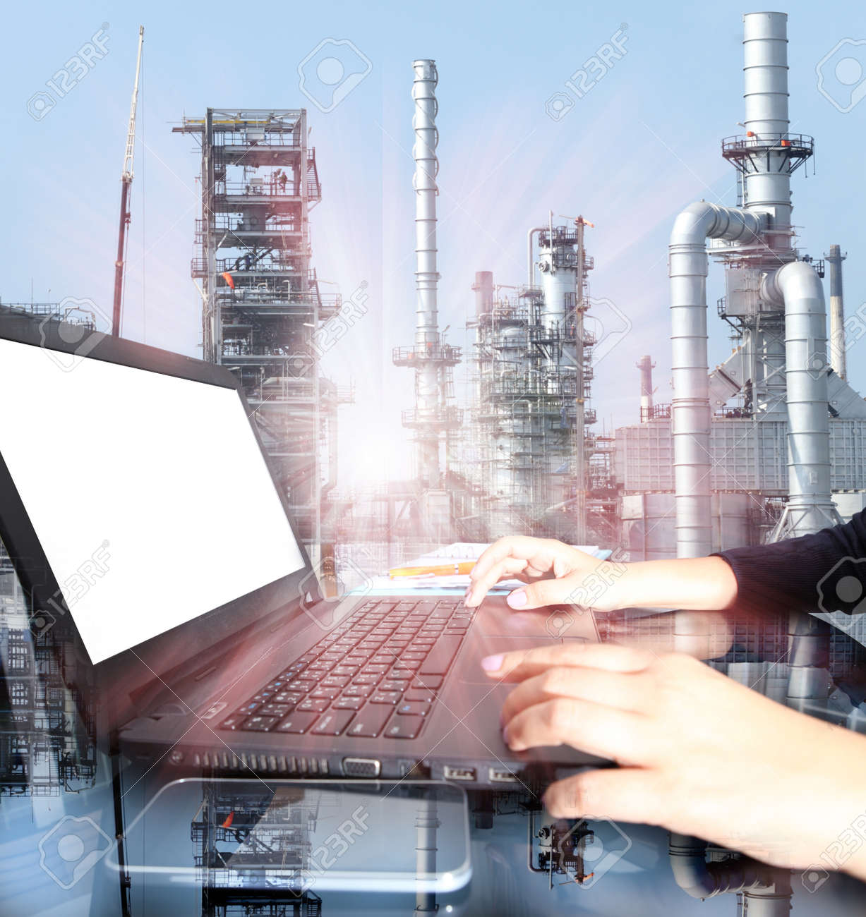 Business woman hand working on laptop computer with oil refinery industry in metallic color style use as metal style of heavy industry background - 47668734 Business woman hand working on laptop computer with oil refinery industry in metallic color style use as metal style of heavy industry background - 47668734