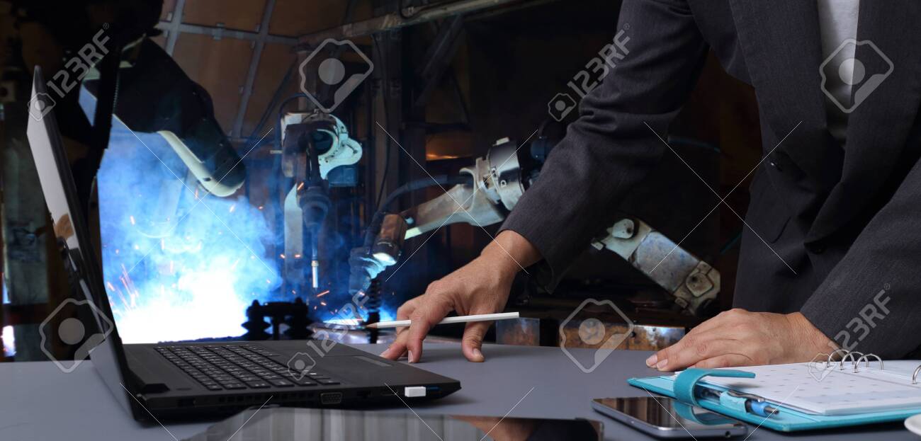 Industry 4.0 , Engineer check and control welding robotics automatic arms machine. in intelligent factory automotive industrial - 122322753 Industry 4.0 , Engineer check and control welding robotics automatic arms machine. in intelligent factory automotive industrial - 122322753