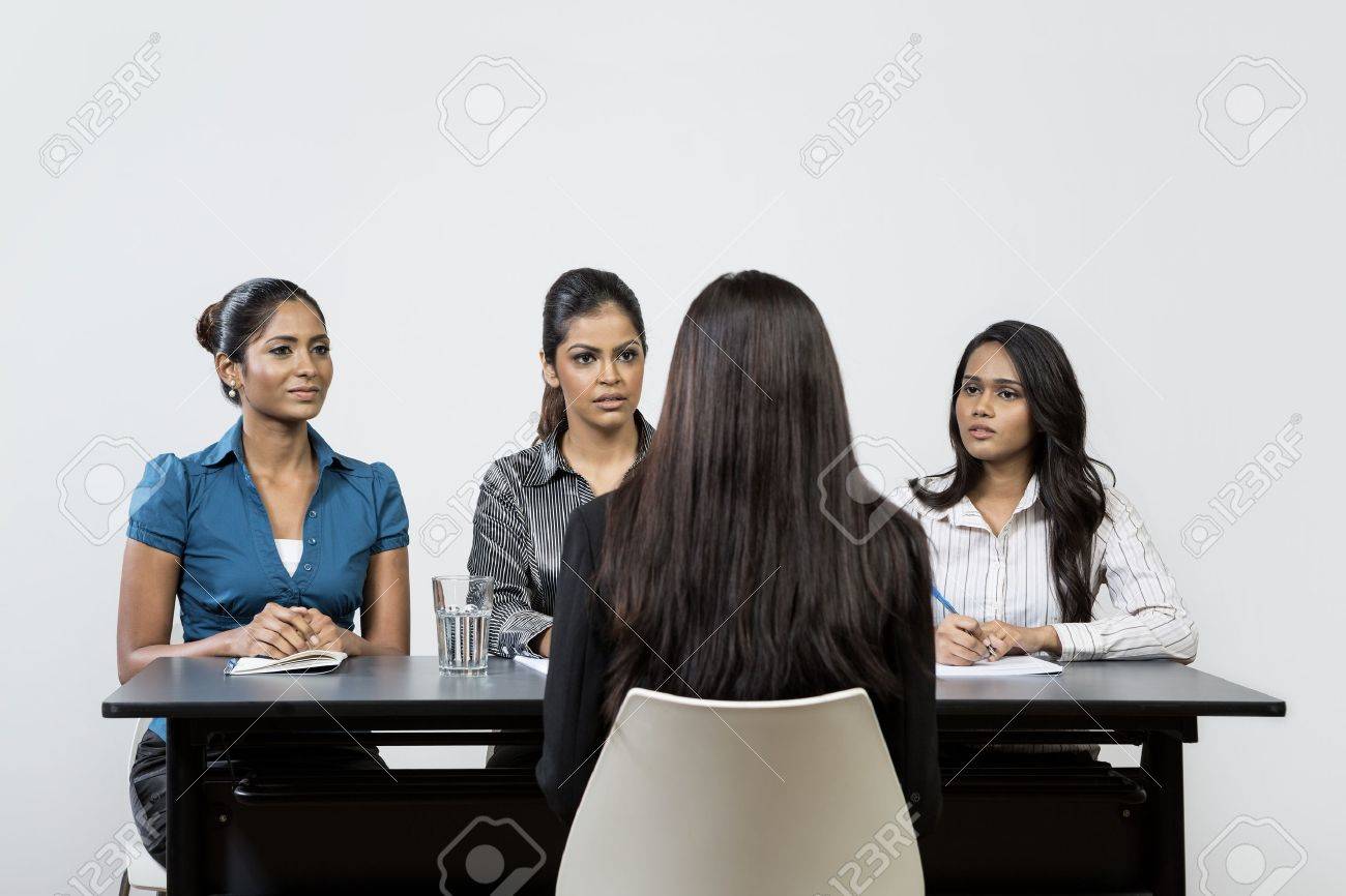 Three Indian colleagues from HR department interview a young female applicant. - 16771686 Three Indian colleagues from HR department interview a young female applicant. - 16771686