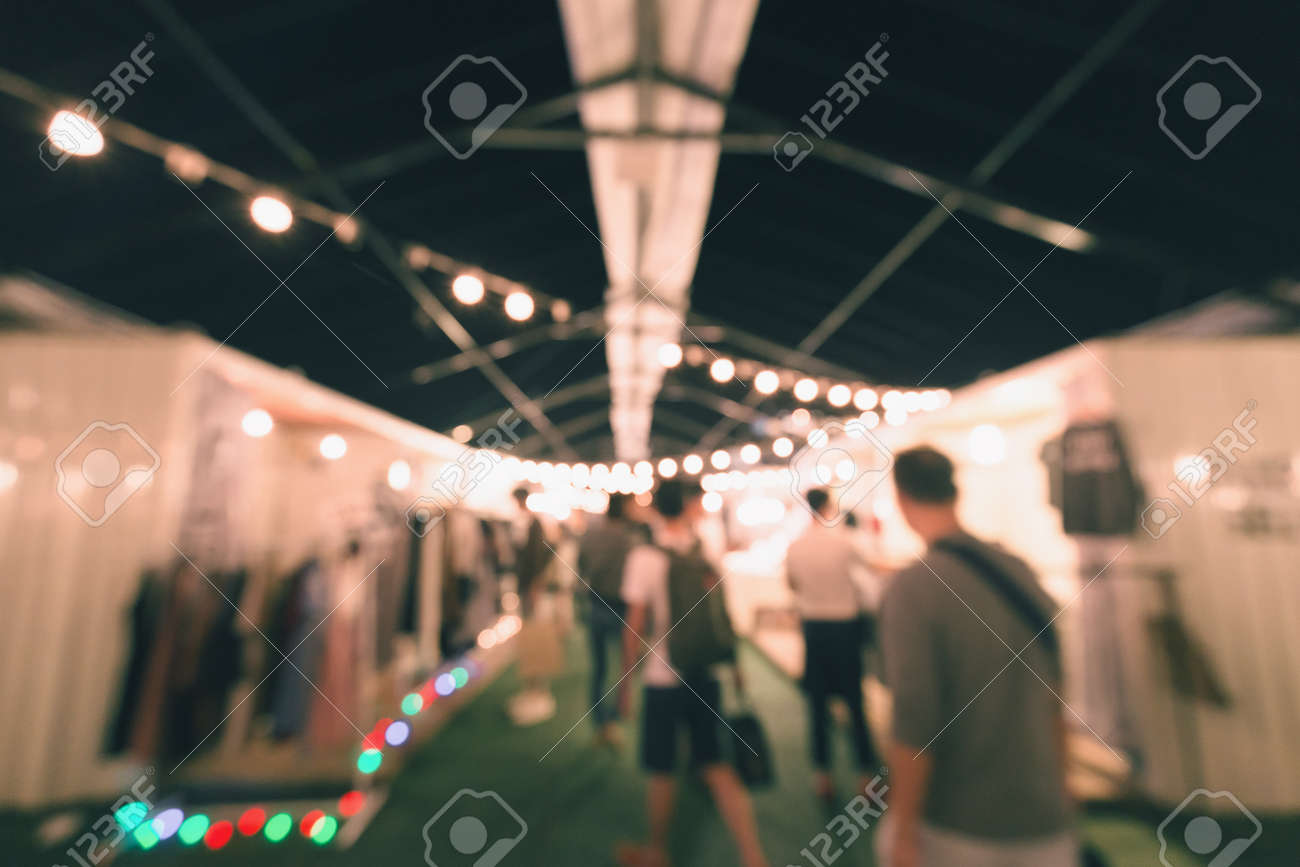 Blurry Scene Of Outdoor Night Market Decorated By Hanging Lamps