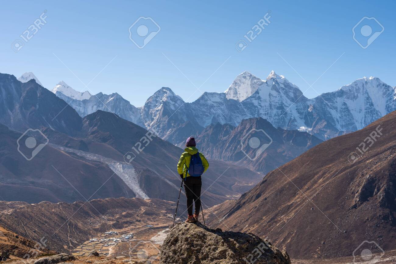 A trekker standing in front of Himalaya mountain range in Everest region, Nepal, Asia - 142566217 A trekker standing in front of Himalaya mountain range in Everest region, Nepal, Asia - 142566217