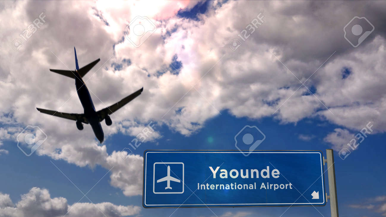 Jet plane landing in Yaounde, Cameroon. City arrival with airport direction sign. Travel, business, tourism and transport concept. 3D rendering. - 170077435 Jet plane landing in Yaounde, Cameroon. City arrival with airport direction sign. Travel, business, tourism and transport concept. 3D rendering. - 170077435