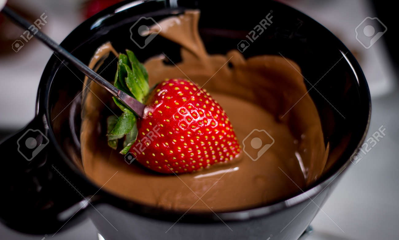 Chocolate fondue with fresh berries on wooden table - 144315352 Chocolate fondue with fresh berries on wooden table - 144315352