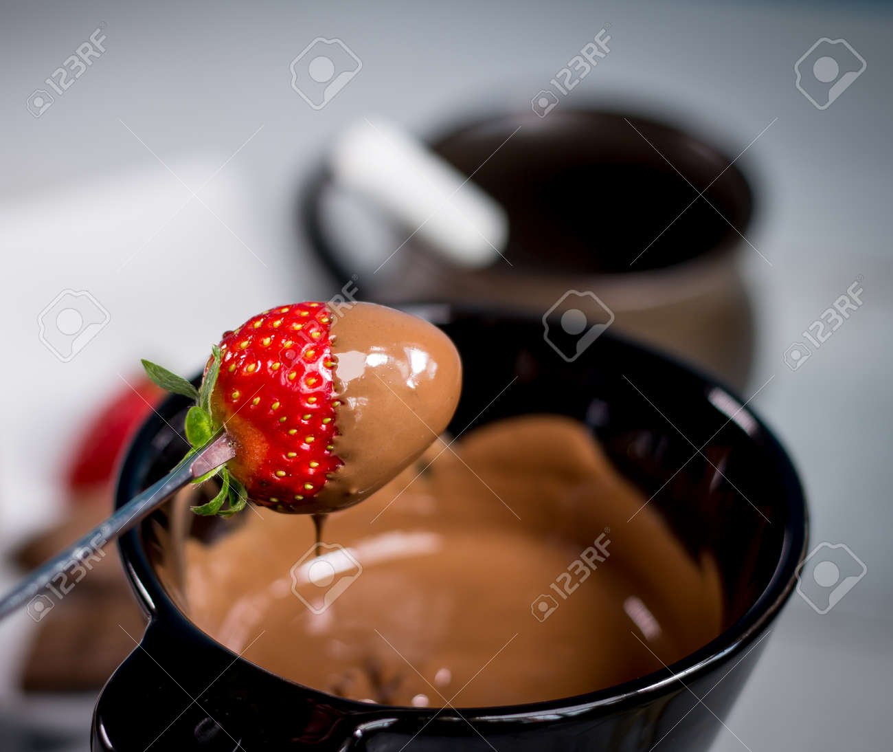 Chocolate fondue with fresh berries on wooden table - 144315355 Chocolate fondue with fresh berries on wooden table - 144315355